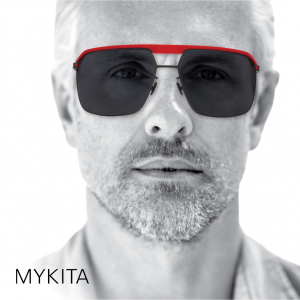 Man wearing red and gunmetal aviator sunglasses in a Mykita eyewear ad